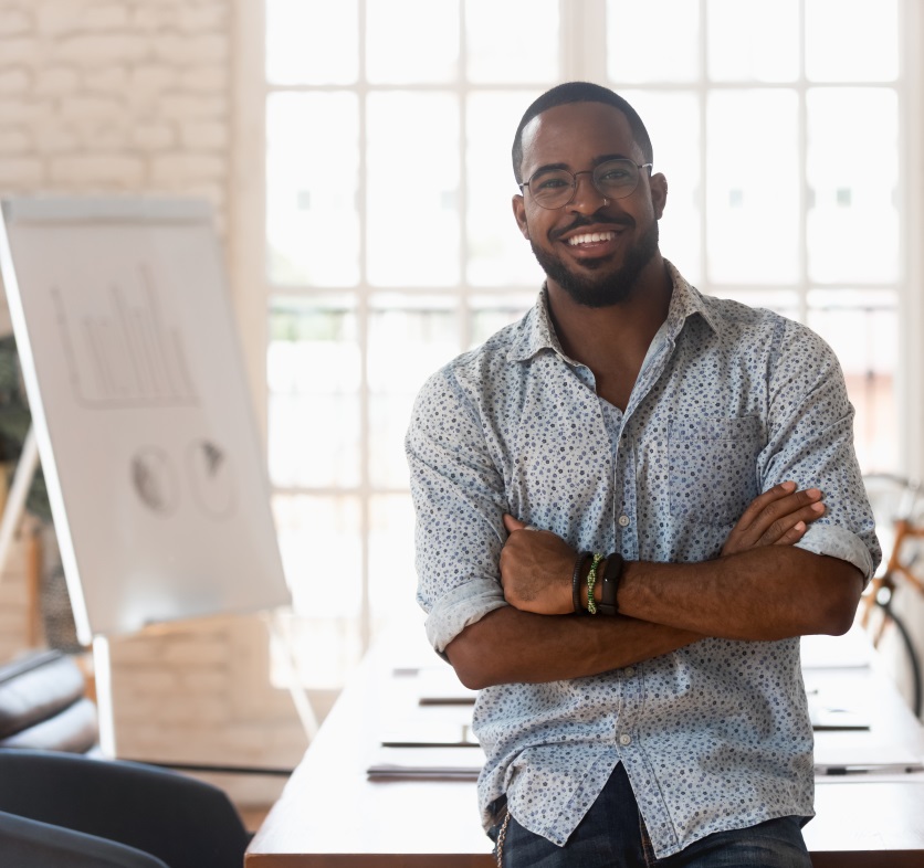 Smiling confident african american young businessman portrait. Sweetgrass Marketing